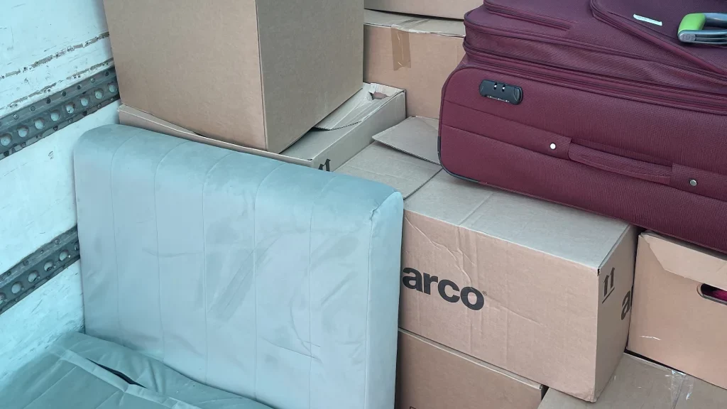 Mover carefully packing fragile items for local micro-move